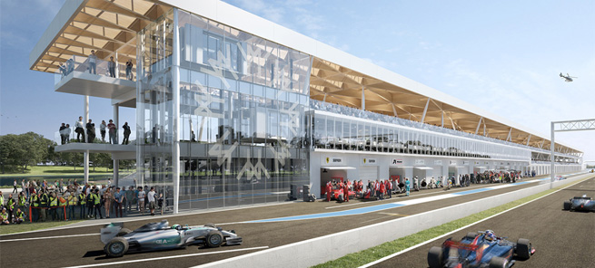 Bâtiment moderne en verre sur un circuit automobile, écuries et voitures de course en action