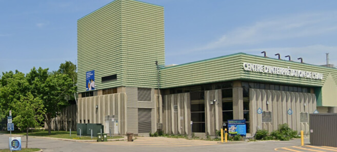 Musée d'art contemporain en verre avec espace public et visiteurs a l'exterieur.